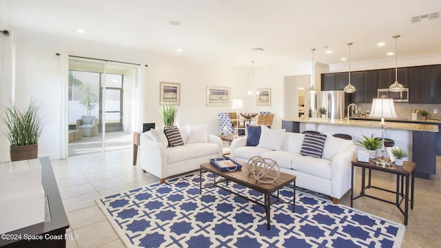 living room with light tile patterned floors and ornamental molding