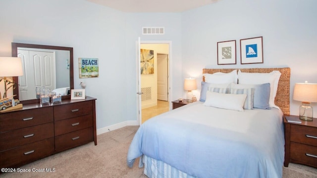 bedroom featuring a closet and light carpet