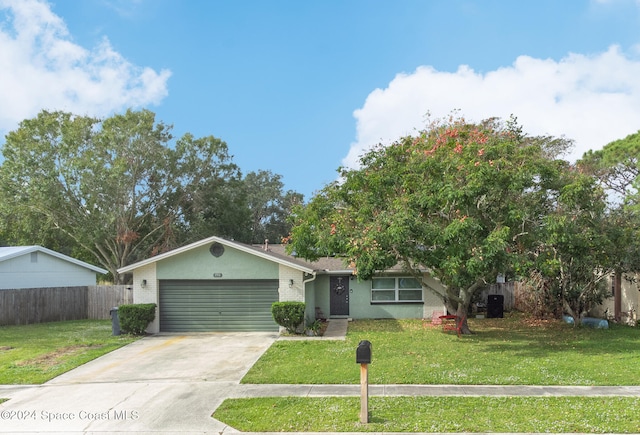 view of front of property featuring a front lawn and a garage