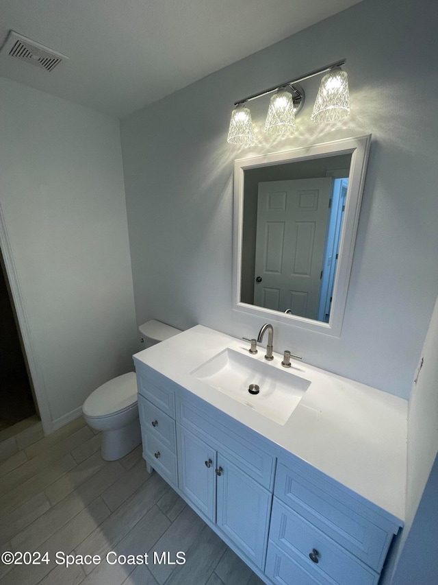 bathroom featuring vanity and toilet