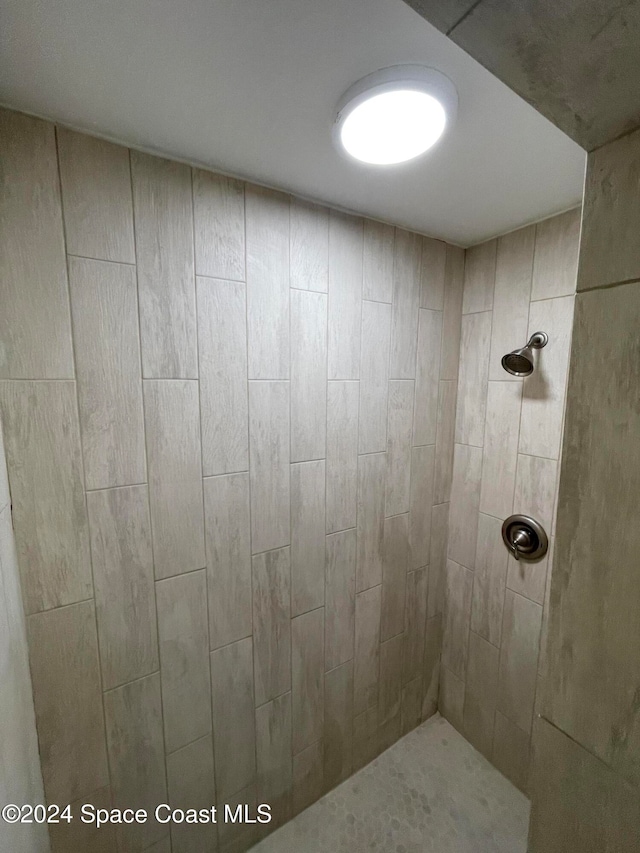 bathroom with tiled shower