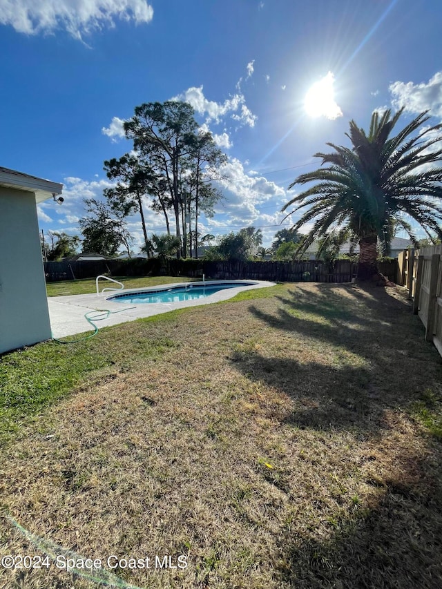 view of yard featuring a fenced in pool and a patio