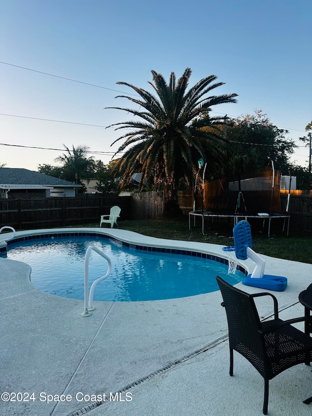 view of pool with a patio and a trampoline