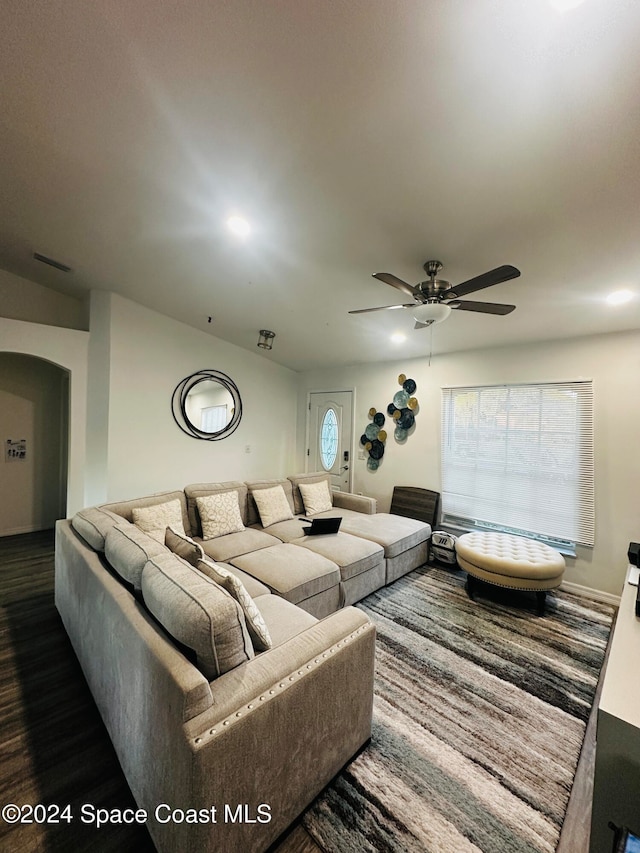 living room with ceiling fan and dark hardwood / wood-style floors