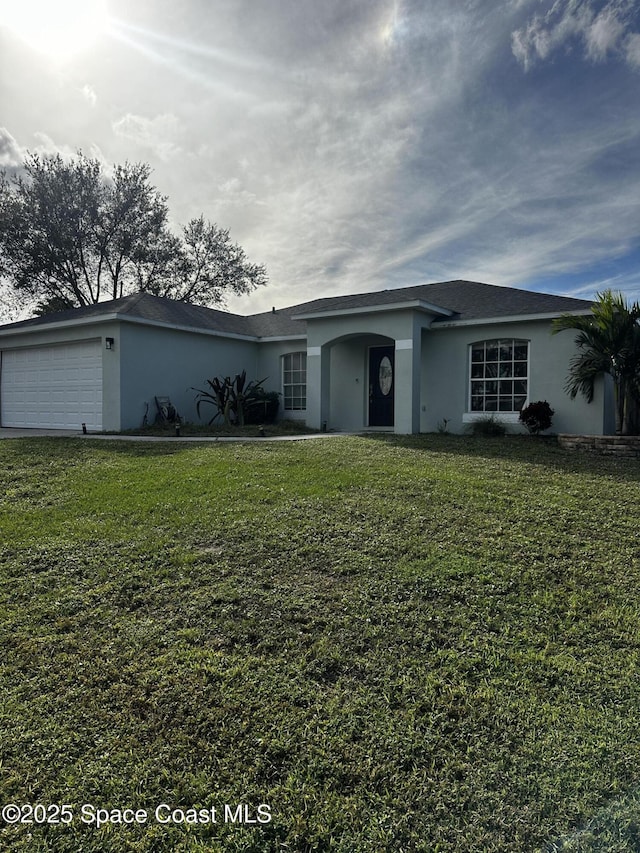 ranch-style house featuring a garage and a front lawn