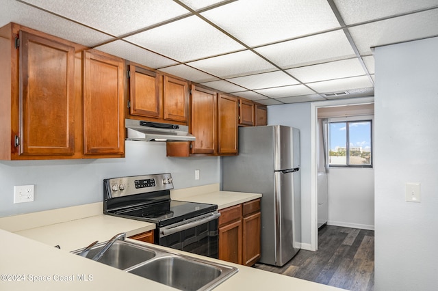 kitchen with sink, a drop ceiling, dark hardwood / wood-style floors, and appliances with stainless steel finishes