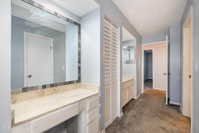 bathroom with vanity and a textured ceiling