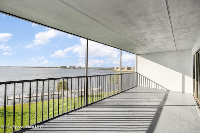 unfurnished sunroom featuring a water view