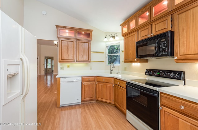 kitchen featuring light hardwood / wood-style flooring, lofted ceiling, sink, and white appliances