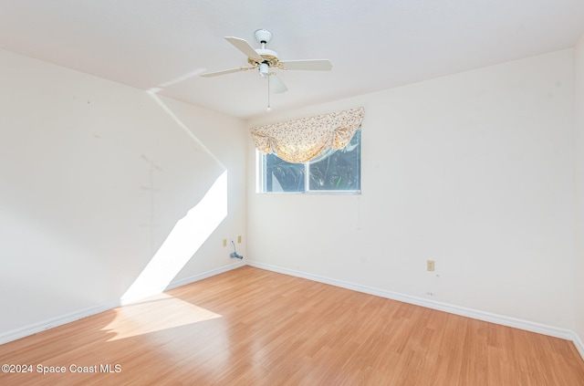 unfurnished room featuring hardwood / wood-style floors and ceiling fan