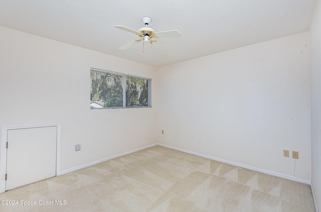 empty room featuring light colored carpet and ceiling fan