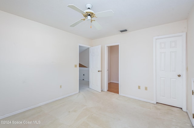 unfurnished bedroom with light carpet and ceiling fan