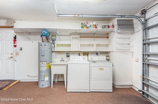 clothes washing area with water heater, washer and dryer, and carpet floors