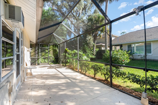 unfurnished sunroom with a wall mounted AC