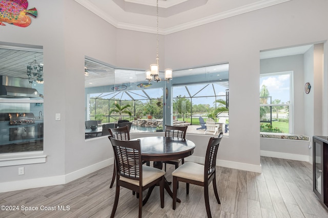 dining space with crown molding and light hardwood / wood-style floors