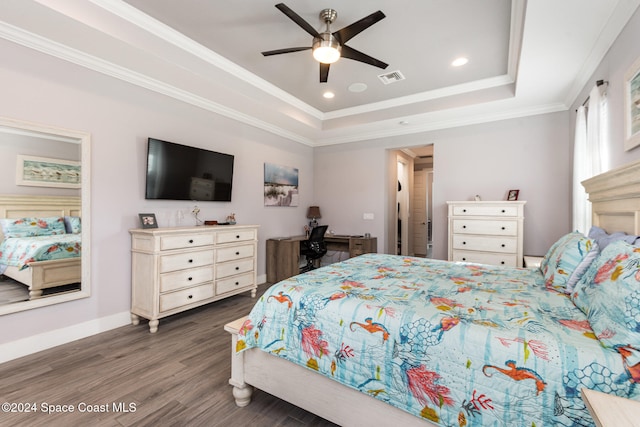 bedroom featuring a raised ceiling, ceiling fan, dark hardwood / wood-style floors, and ornamental molding