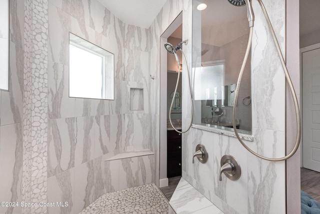 bathroom with a tile shower