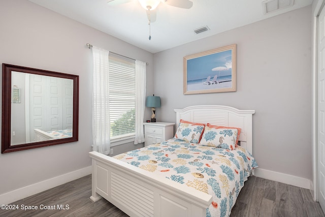 bedroom with dark hardwood / wood-style floors and ceiling fan