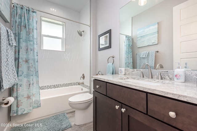 full bathroom with toilet, vanity, and shower / tub combo with curtain