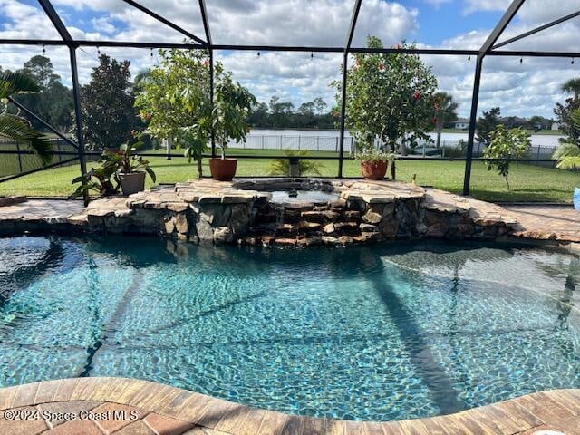 view of swimming pool with a yard and a lanai