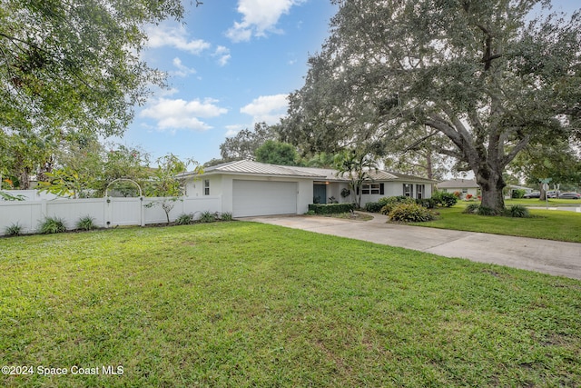 ranch-style home featuring a garage and a front lawn