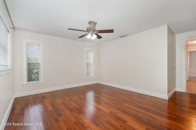 unfurnished room featuring ceiling fan, dark hardwood / wood-style floors, and a textured ceiling