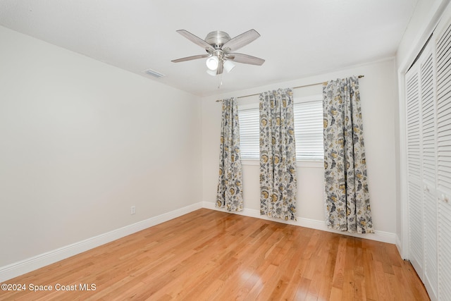 spare room with wood-type flooring and ceiling fan