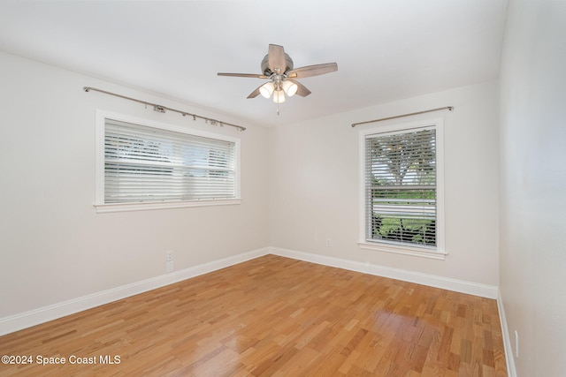 spare room featuring hardwood / wood-style floors and ceiling fan