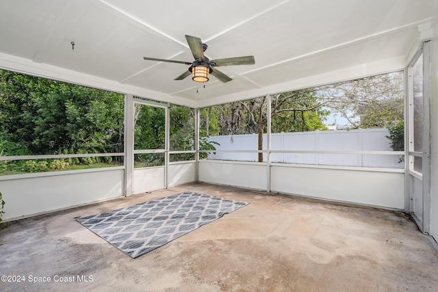 unfurnished sunroom with ceiling fan