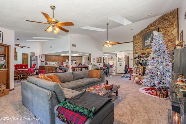 living room featuring ceiling fan, light carpet, and high vaulted ceiling