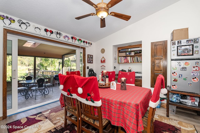 dining area featuring hardwood / wood-style floors, vaulted ceiling, and ceiling fan