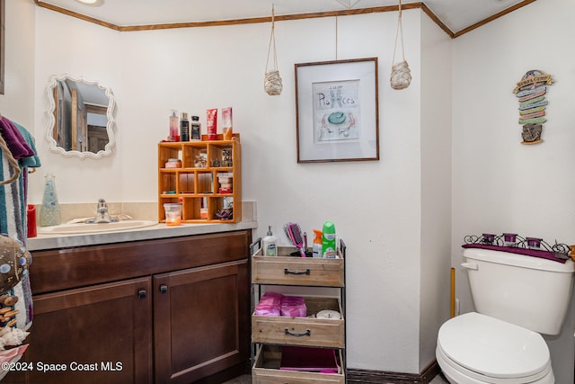 bathroom featuring vanity, toilet, and ornamental molding