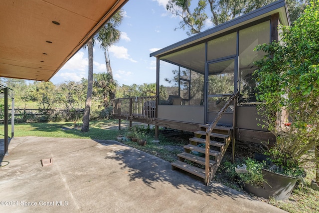 exterior space with a sunroom and a deck