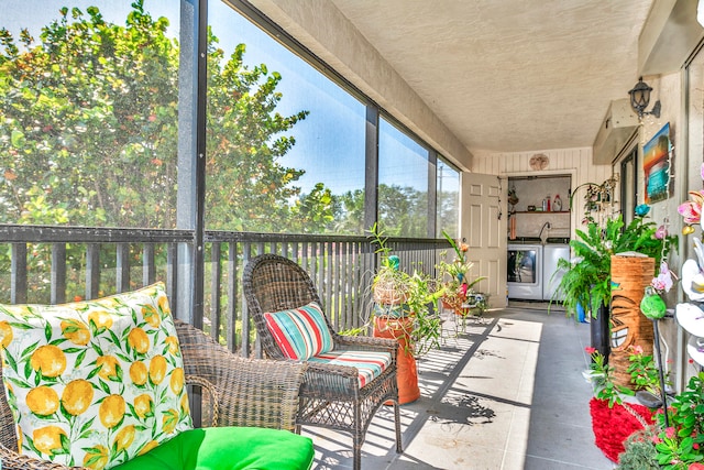 sunroom with washer and clothes dryer