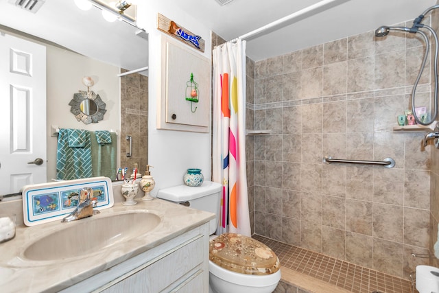 bathroom featuring curtained shower, vanity, and toilet