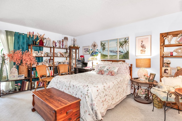 bedroom with a textured ceiling and carpet flooring