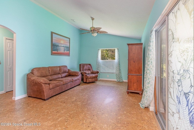 living room featuring a textured ceiling, ceiling fan, and vaulted ceiling