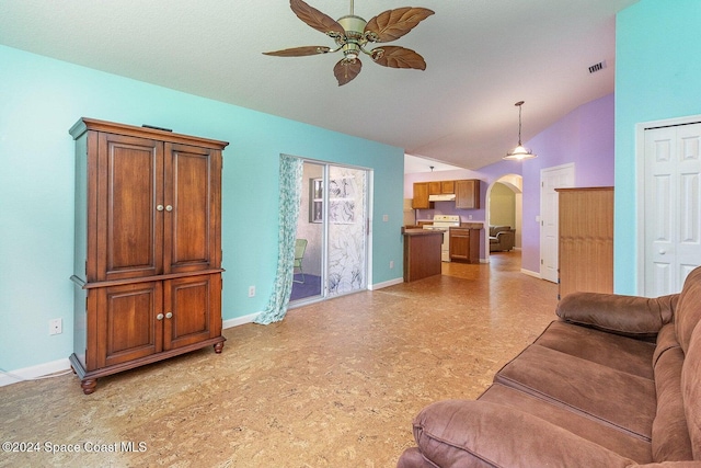 living room featuring vaulted ceiling and ceiling fan