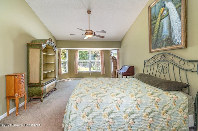 carpeted bedroom featuring a textured ceiling, ceiling fan, and vaulted ceiling