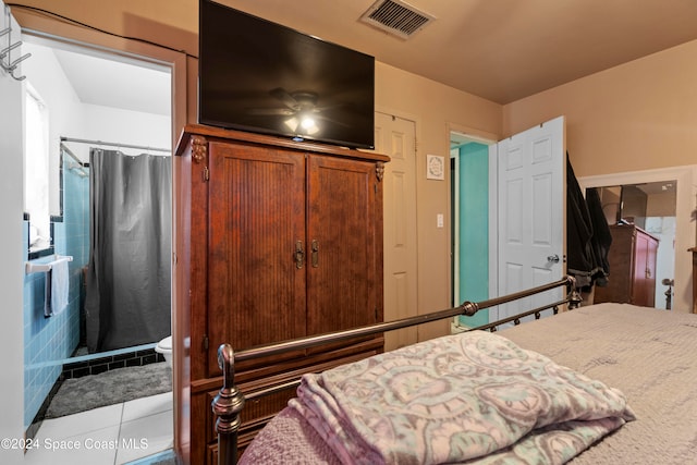 bedroom with ceiling fan and light tile patterned flooring