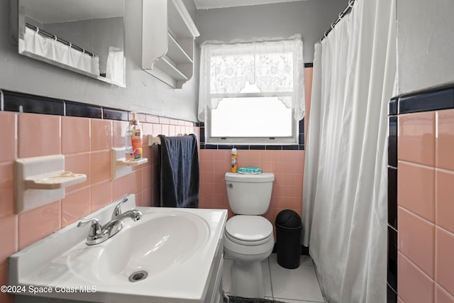 bathroom with sink, tile patterned flooring, toilet, tile walls, and walk in shower