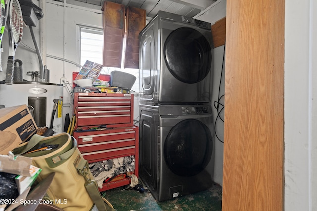 laundry room with gas water heater and stacked washer and clothes dryer