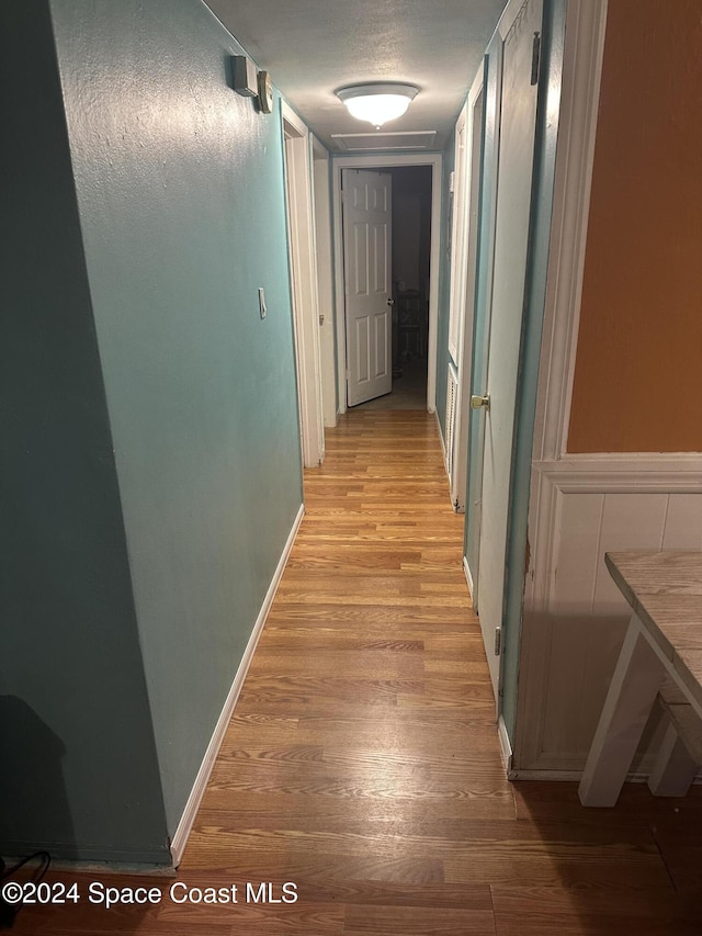 corridor with light wood-type flooring