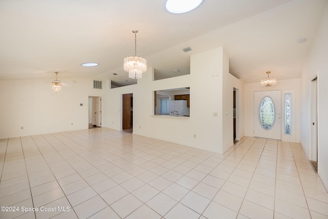 interior space with lofted ceiling and ceiling fan with notable chandelier