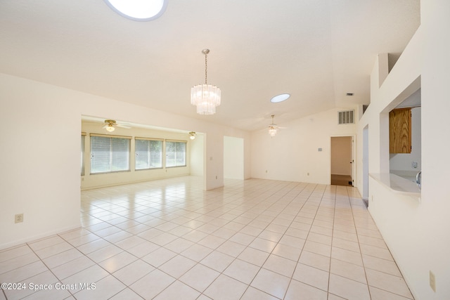 unfurnished room featuring light tile patterned flooring, lofted ceiling, and ceiling fan with notable chandelier