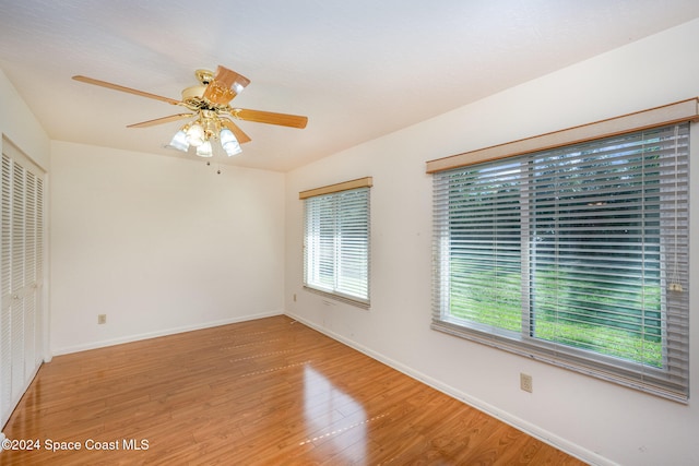 empty room featuring wood-type flooring and ceiling fan