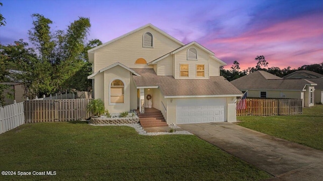 view of property with a garage and a yard