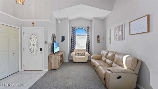 carpeted foyer featuring vaulted ceiling