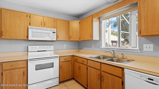 kitchen featuring sink, white appliances, and light tile patterned flooring