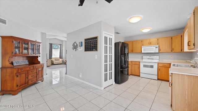 kitchen with white appliances, ceiling fan, sink, and light tile patterned flooring